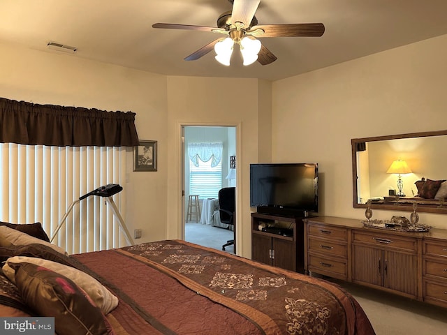 bedroom with ceiling fan, visible vents, and light colored carpet