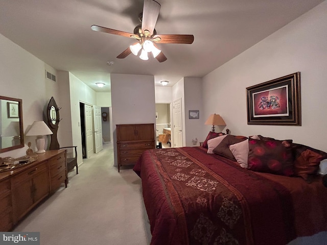 bedroom with a ceiling fan, visible vents, and light carpet