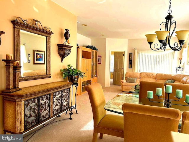 dining room featuring light carpet and an inviting chandelier