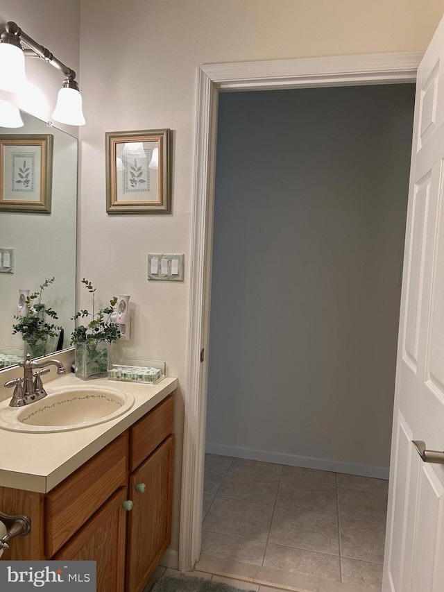 bathroom featuring vanity, baseboards, and tile patterned floors