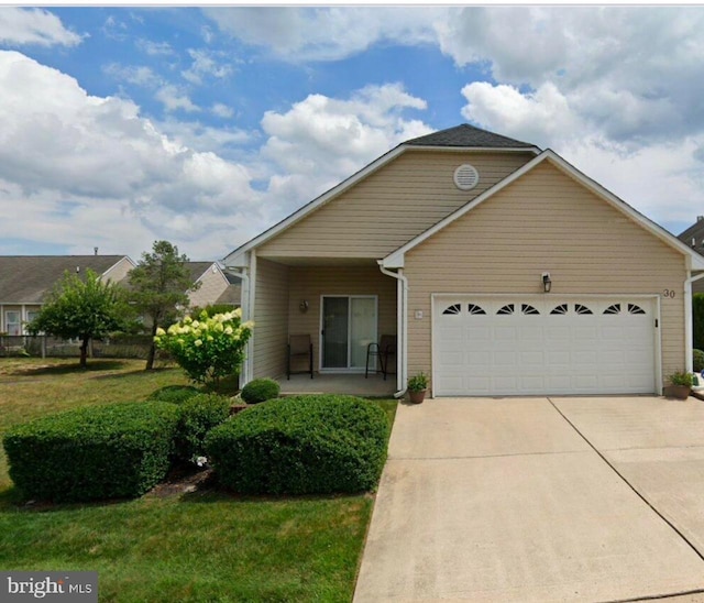 view of front facade with a garage, driveway, and a front lawn