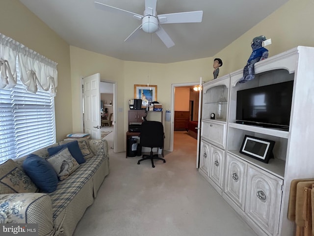 living room featuring a ceiling fan and light carpet