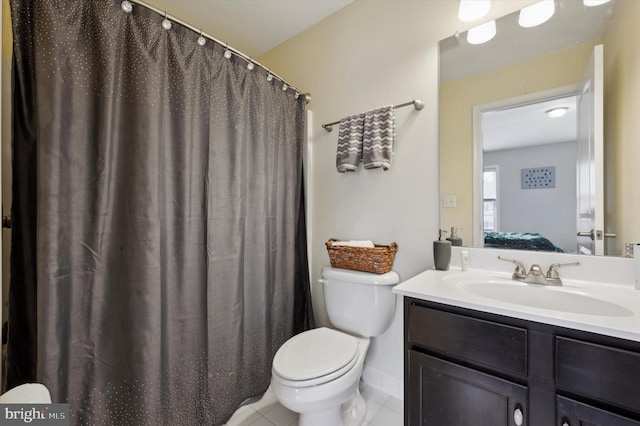 bathroom featuring tile patterned flooring, vanity, and toilet