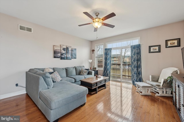 living room with hardwood / wood-style flooring and ceiling fan