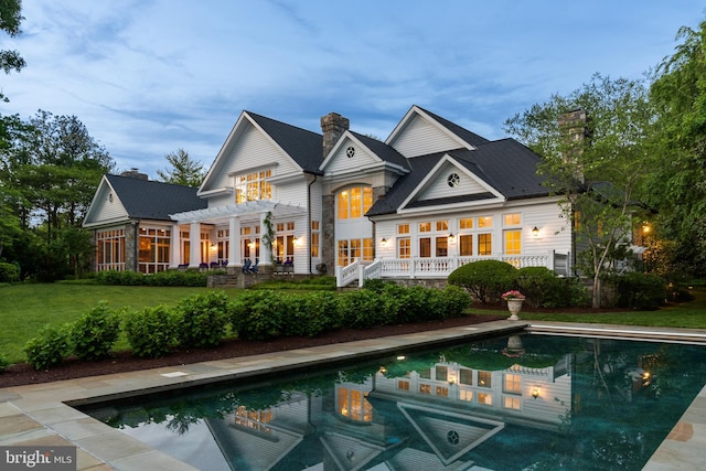 948 Melvin Rd, Annapolis, MD 21403 - rear view of property featuring a pergola, an outdoor pool, a chimney, and a lawn