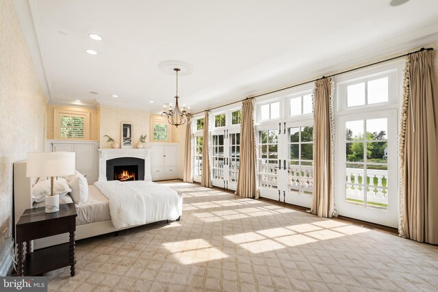 948 Melvin Rd, Annapolis, MD 21403 - bedroom with access to outside, crown molding, french doors, a chandelier, and a large fireplace