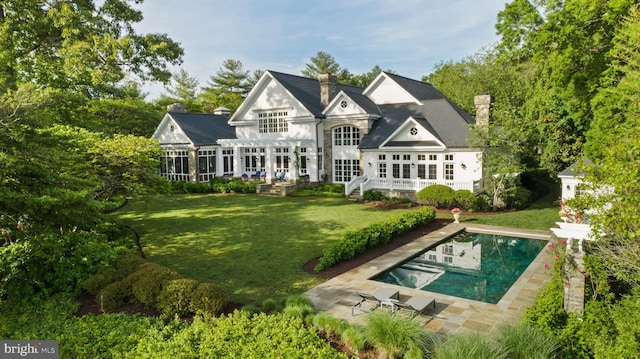 948 Melvin Rd, Annapolis, MD 21403 - back of house with a pergola, a chimney, a lawn, an outdoor pool, and a patio area