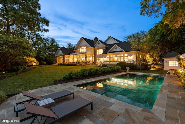 948 Melvin Rd, Annapolis, MD 21403 - rear view of property featuring a lawn, a patio, and an outdoor pool