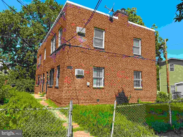 view of property exterior featuring a wall mounted AC