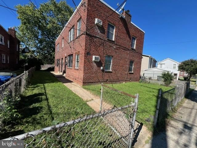 view of side of home with a yard