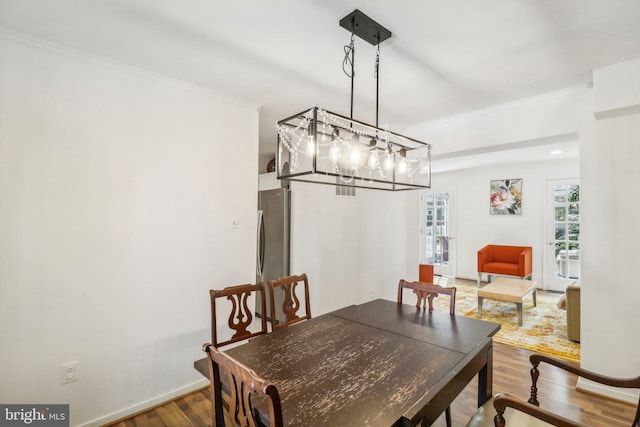 dining area featuring crown molding and wood-type flooring