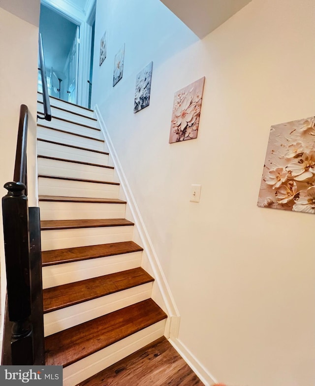 stairway featuring hardwood / wood-style floors