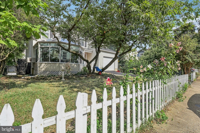 view of property hidden behind natural elements with a front lawn