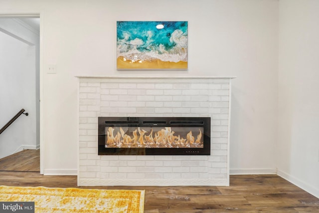 interior details with wood-type flooring and a fireplace