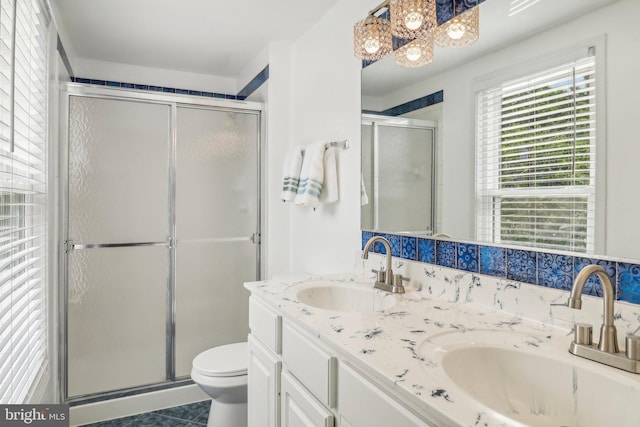 bathroom featuring an enclosed shower, vanity, tile patterned floors, and toilet