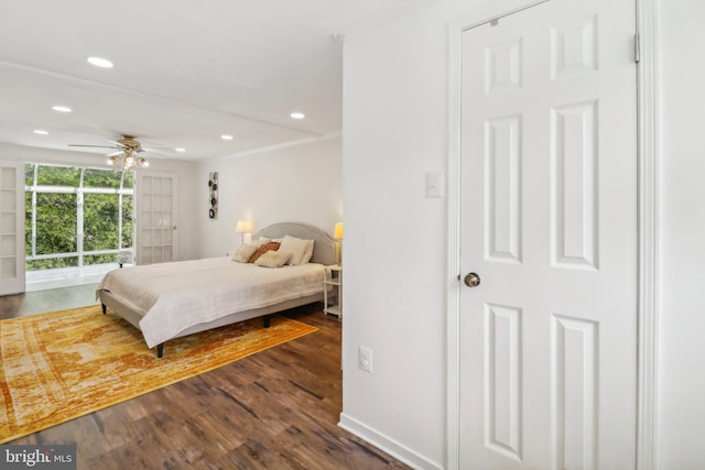 bedroom featuring ceiling fan, access to exterior, and dark hardwood / wood-style flooring