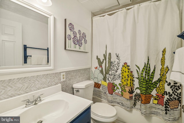 full bathroom with vanity, toilet, and shower / bath combo with shower curtain