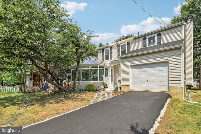 view of front property featuring a garage and a sunroom