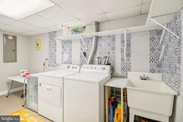 washroom with separate washer and dryer, electric panel, and sink