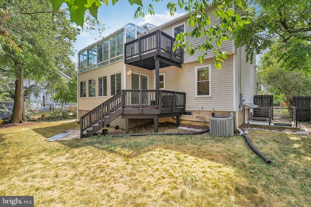 back of house with cooling unit, a deck, a sunroom, and a lawn