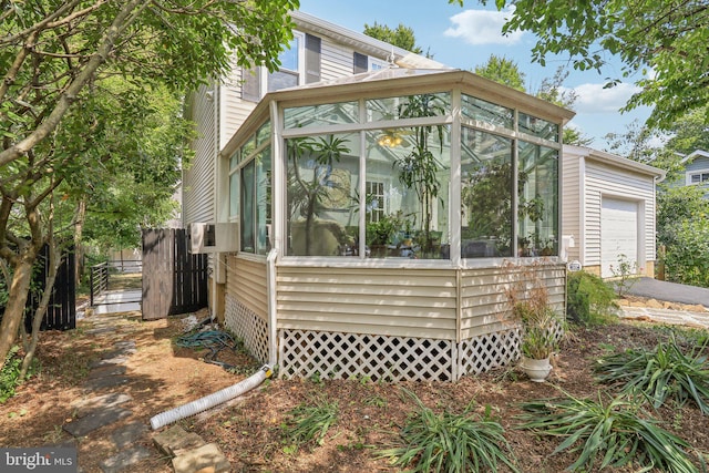 view of home's exterior featuring cooling unit and a sunroom