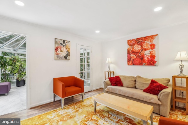 living room with ornamental molding and hardwood / wood-style floors