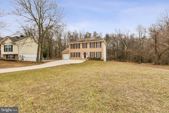 view of front of house featuring a garage and a front lawn