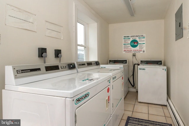 laundry room with light tile patterned flooring, a baseboard heating unit, washing machine and clothes dryer, and electric panel