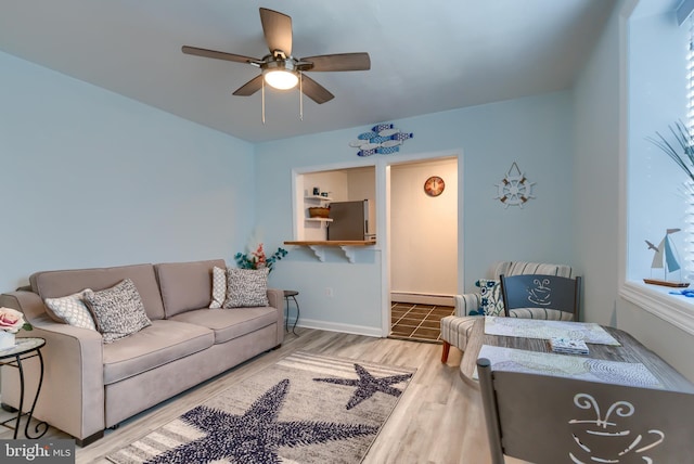 living room with wood-type flooring, a baseboard heating unit, and ceiling fan