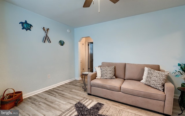 living room with ceiling fan and light wood-type flooring