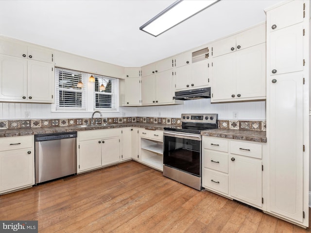 kitchen with stainless steel appliances, sink, light hardwood / wood-style flooring, and white cabinets