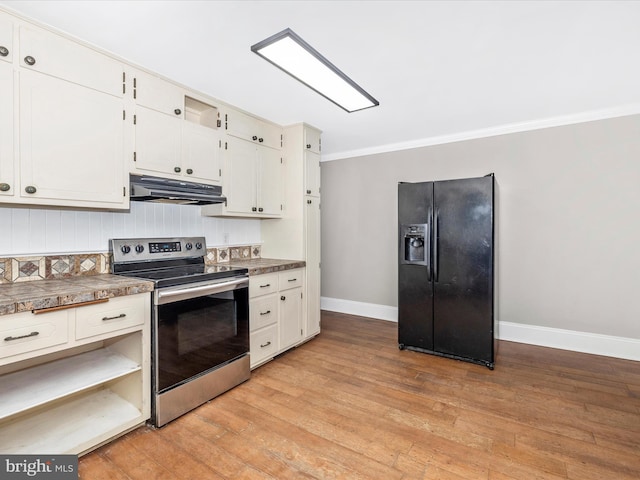 kitchen with black fridge, white cabinetry, stainless steel electric stove, and light hardwood / wood-style floors