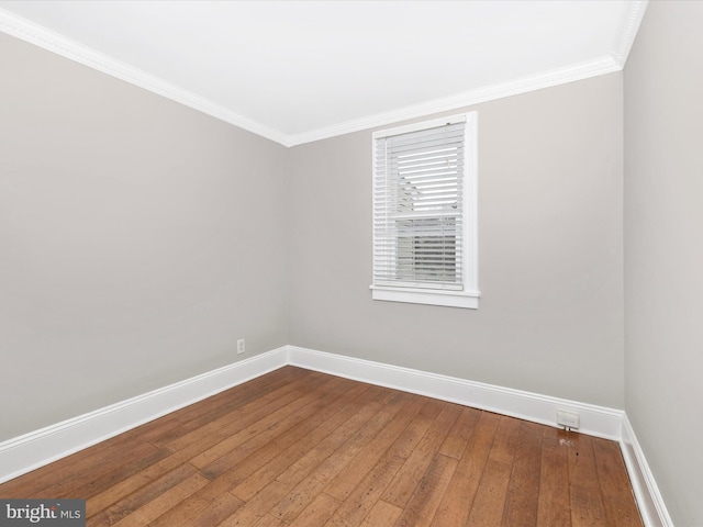 unfurnished room with ornamental molding and hardwood / wood-style floors