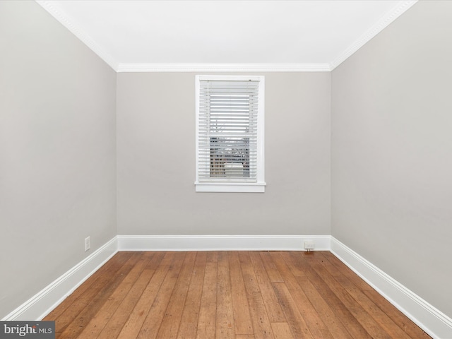 spare room with hardwood / wood-style flooring and ornamental molding