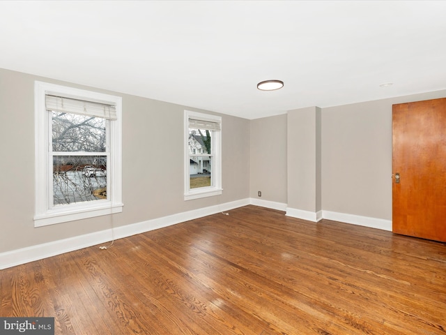 unfurnished room featuring hardwood / wood-style floors and a wealth of natural light