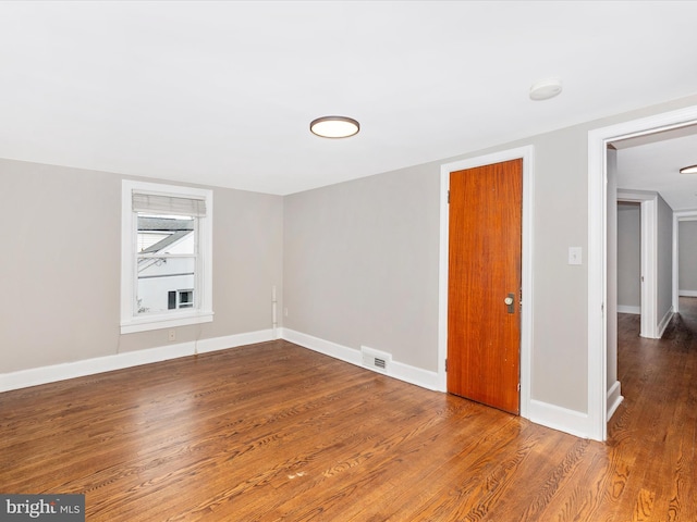 empty room featuring wood-type flooring