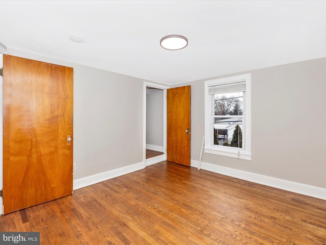 unfurnished room featuring hardwood / wood-style flooring