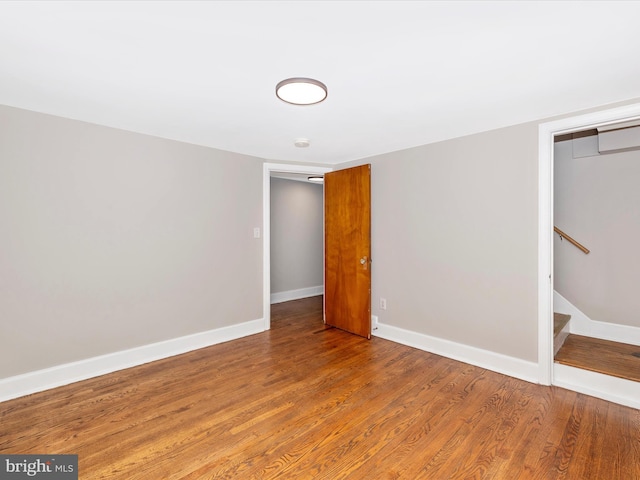 unfurnished bedroom with hardwood / wood-style flooring and a closet