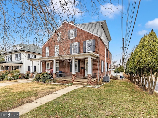 view of front of house with a porch, a front yard, and central air condition unit