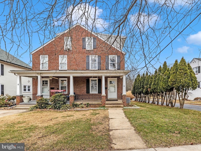 view of front facade with a porch and a front yard