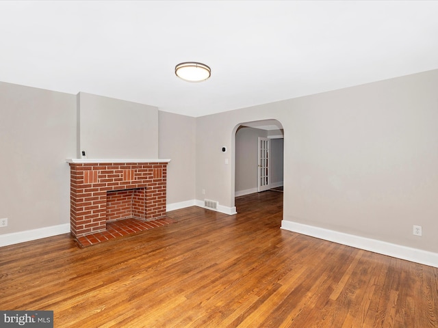 unfurnished living room with hardwood / wood-style flooring and a fireplace