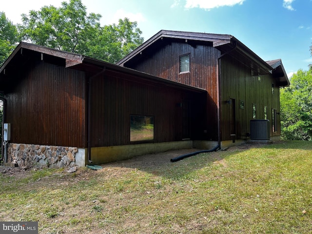 view of side of home featuring a yard and central air condition unit