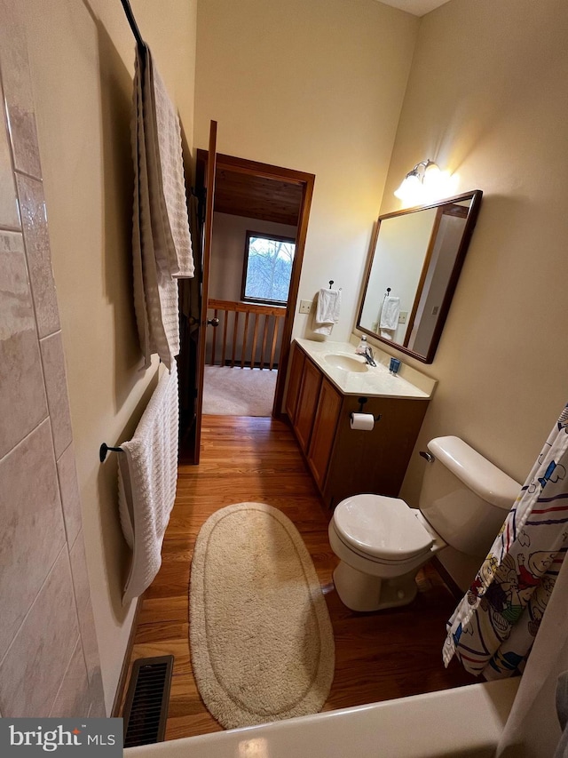 bathroom featuring hardwood / wood-style flooring, vanity, and toilet