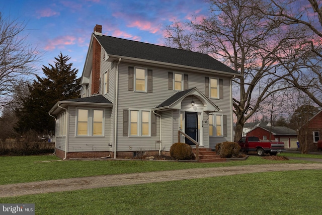 view of front of property with a lawn