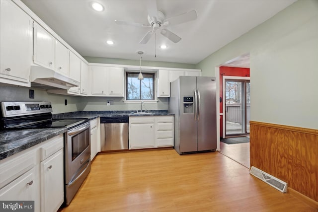 kitchen featuring sink, ceiling fan, appliances with stainless steel finishes, light hardwood / wood-style floors, and white cabinets