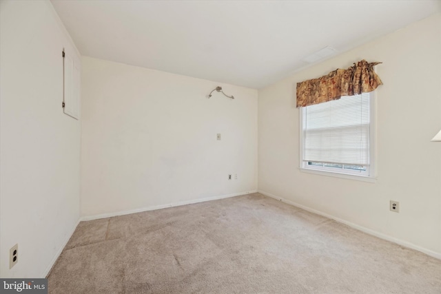 unfurnished room featuring light carpet