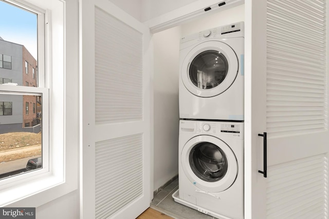 laundry room featuring stacked washing maching and dryer