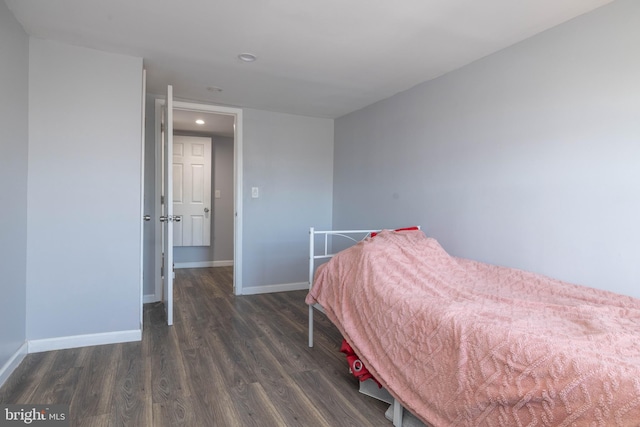 bedroom with dark wood-type flooring