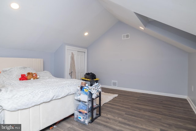 bedroom with lofted ceiling and dark hardwood / wood-style floors