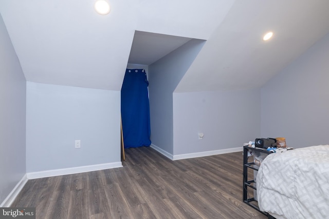 bedroom featuring lofted ceiling and dark hardwood / wood-style floors